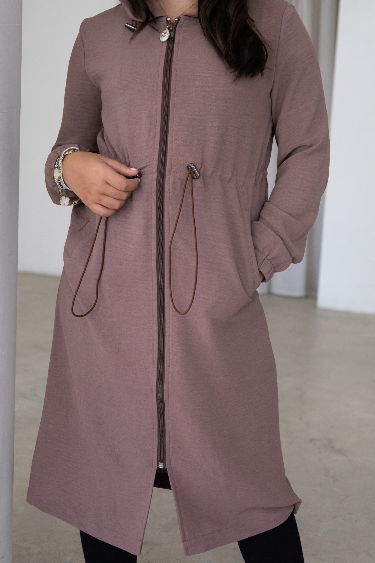 Elegant and modest, The Haya Coat is a timeless girls’ coat designed for comfort and effortless everyday style. Featuring a longline silhouette, hood, adjustable waist and versatile mocha colour, it’s the perfect layer for every occasion.