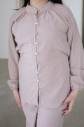 Elegant and effortlessly modest, The Liyana Set is a timeless two-piece outfit designed for comfort and style. Featuring a longline blouse with delicate pearl-look buttons and softly gathered sleeves, paired with relaxed wide-leg pants, it’s perfect for Eid, special occasions, family gatherings and everyday wear.