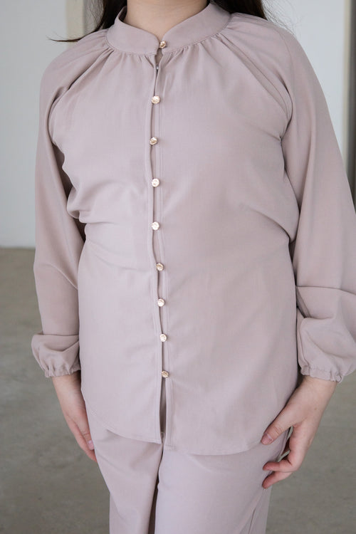 Elegant and effortlessly modest, The Liyana Set is a timeless two-piece outfit designed for comfort and style. Featuring a longline blouse with delicate pearl-look buttons and softly gathered sleeves, paired with relaxed wide-leg pants, it’s perfect for Eid, special occasions, family gatherings and everyday wear.